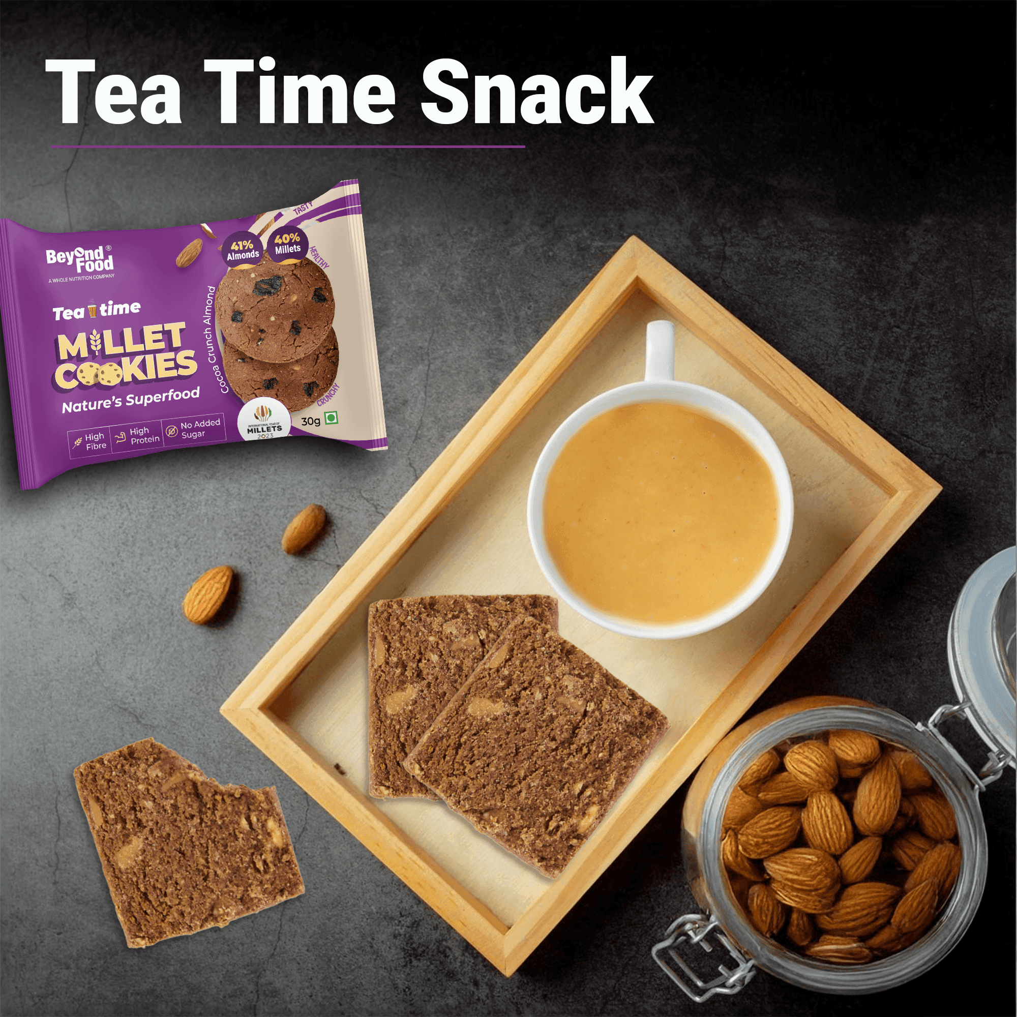Tea time snack setup – Beyond Food Millet Cookies served with tea, almonds, and cookie pieces on a tray.