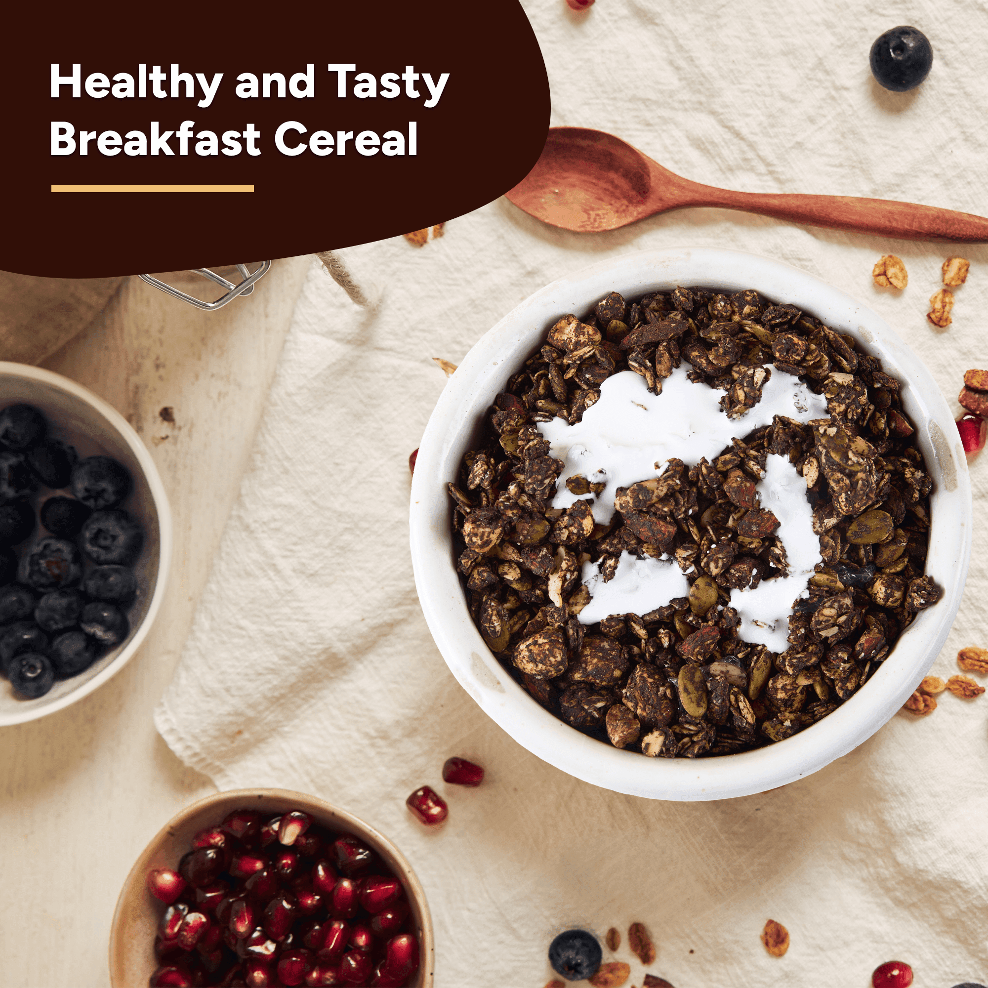 Overhead shot of a bowl filled with Beyond Food Crunchy & Nutty Granola Chocolate, surrounded by pomegranate seeds, blueberries, and a wooden spoon.