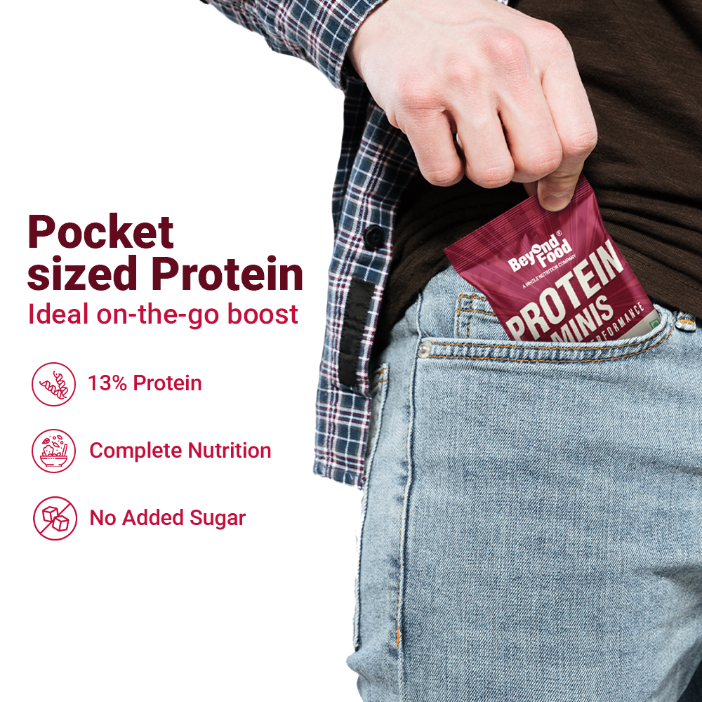 “Hand placing Beyond Food Protein Minis pouch into a jeans pocket with text: ‘Pocket sized Protein, Ideal on-the-go boost, 13% Protein, Complete Nutrition, No Added Sugar’.”